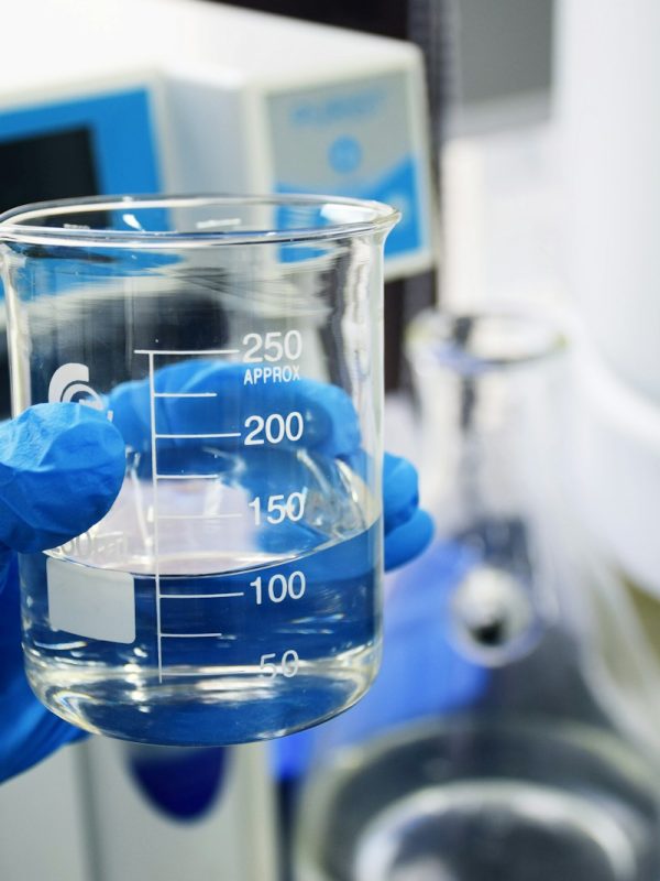 clear glass measuring cup on white table