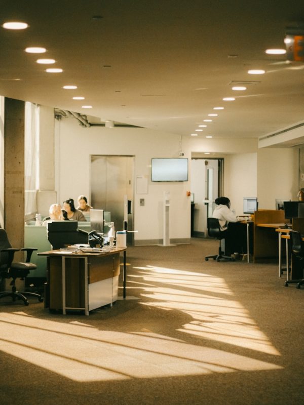 a large open room with people working on their computers